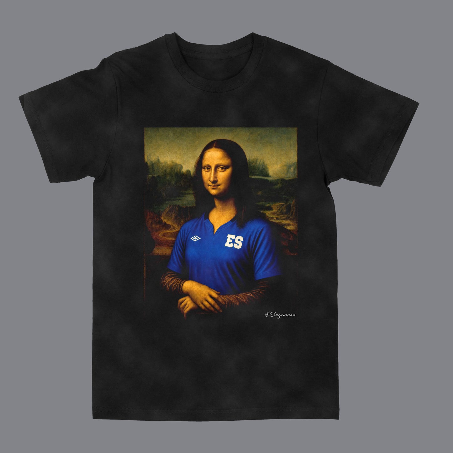 A black short-sleeve t-shirt featuring a custom graphic print of the Mona Lisa wearing a blue soccer jersey with 'ES' on the chest and the Umbro logo. The t-shirt is displayed flat against a solid gray background.