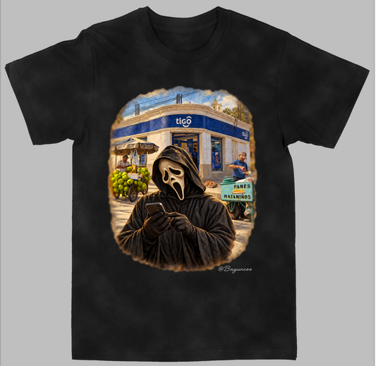 A black short-sleeve crewneck t-shirt featuring a large graphic print on the front. The graphic depicts a person in a black hood with a white Ghostface mask looking at a phone, set against a background of a blue and white shop storefront with a green cart.